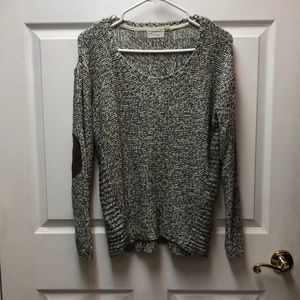 Black and white scoop neck sweater with brown elbow patches